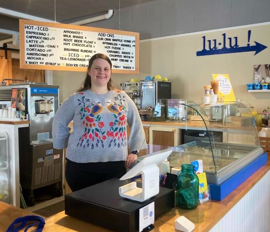 woman standing behind an ice cream counter