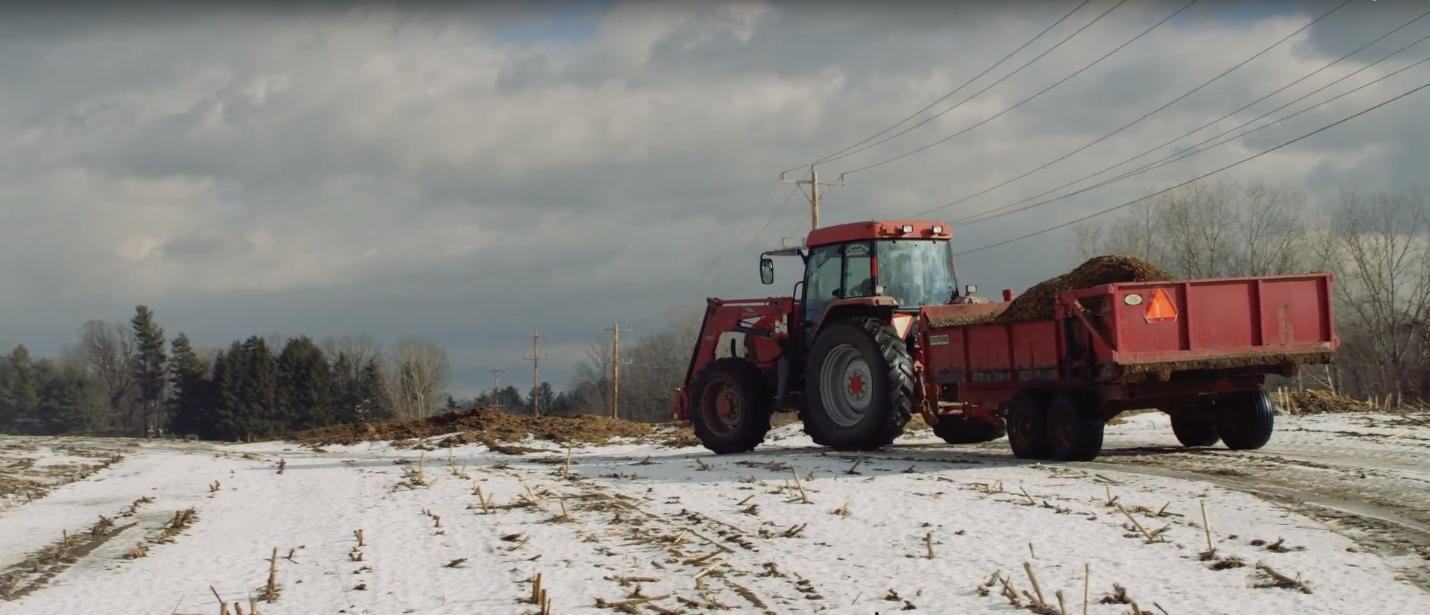 manure spreader on winter field