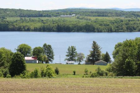 agricultural field sits next to Lake Carmi
