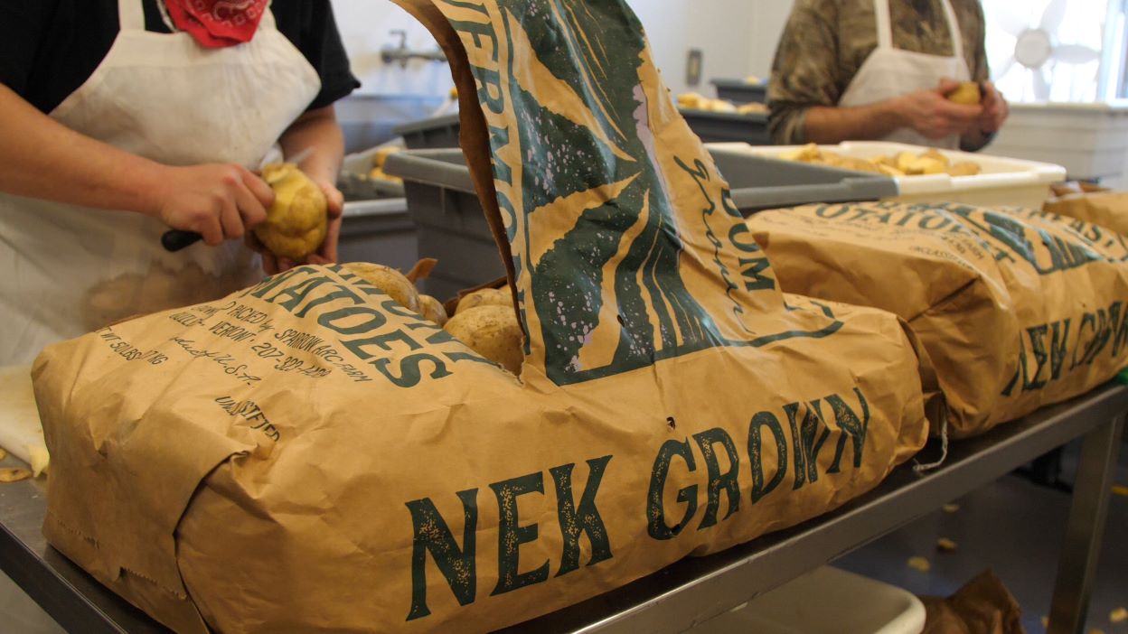 Just Cut production staff peeling NEK Grown potatoes.