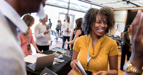 A group of people networking at a trade show