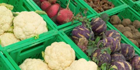 cauliflower, radishes, and beets in green crates