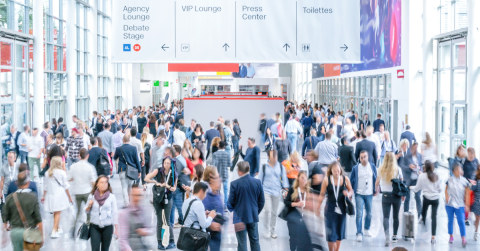 A large crowd on a tradeshow floor.