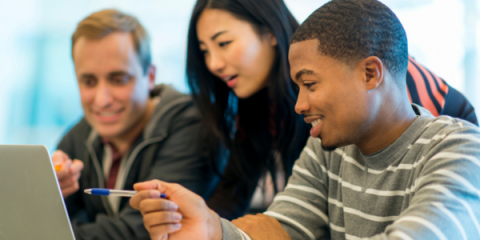 Three people discussing something over a computer