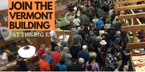 A large crowd walks through the Vermont Building at the Big E