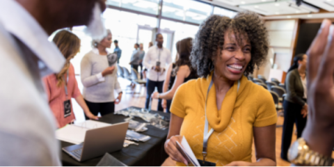 A group of people networking at a trade show