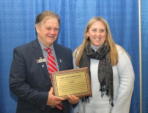 Joe Tisbert, President of Vermont Farm Bureau receives the 2017 John C. Finley Award from Kate Finley Woodruff at the Vermont Dairy Industry Association’s Annual Dairy Banquet at the Vermont Farm show on February 1, 2018