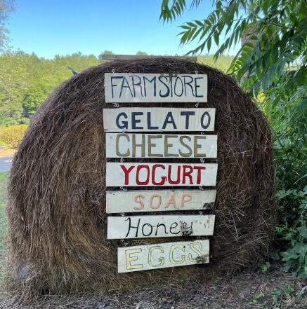 round bale with hand painted farm store signs 